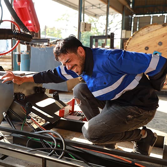 Man using machinery and bent over with lower back pain