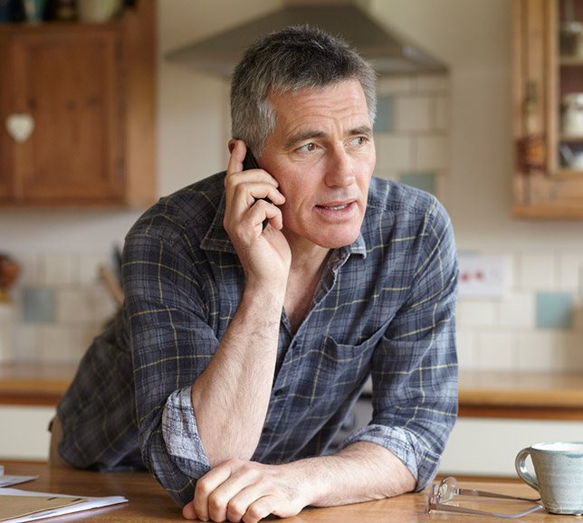 Man taking a phone call in his kitchen