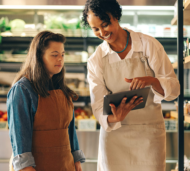 Shop workers talking while looking at tablet