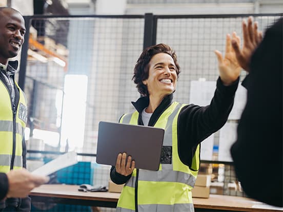 Woman factory working giving her colleague a high five