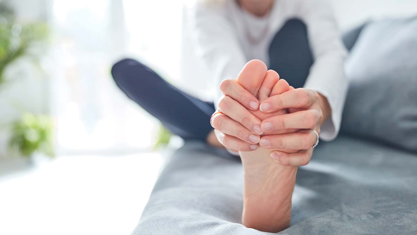 Woman holding her foot in pain